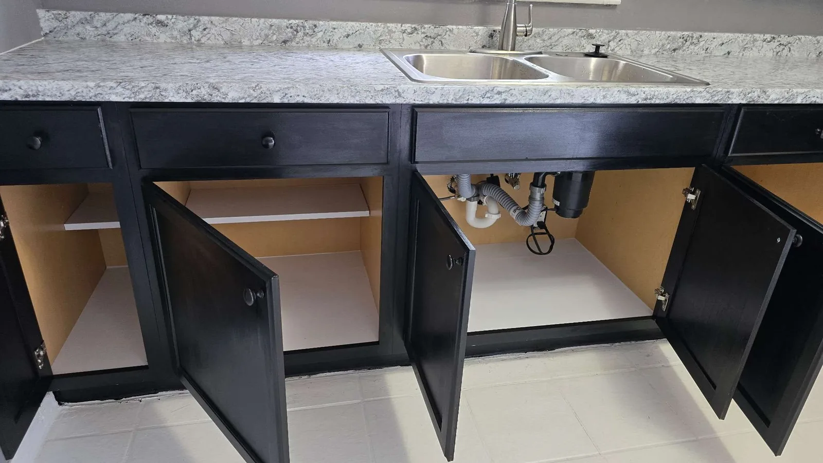 Cleaned kitchen cabinet interiors with fresh shelf liners after the rehab clean